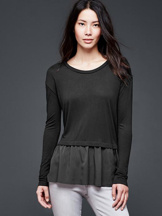 View large product image 1 of 1. Mix-media peplum top