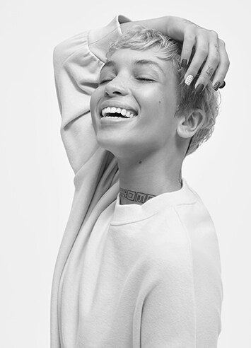 Black and white photo of a woman laughing