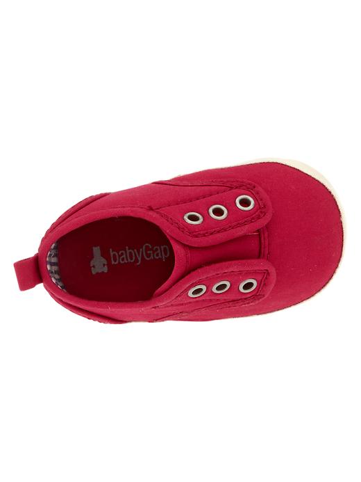 View large product image 2 of 3. Red canvas slip-on sneakers