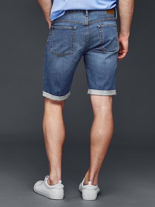 2 of 8 showing, with the color worn medium blue of product STRETCH 1969 slim fit denim shorts (10")