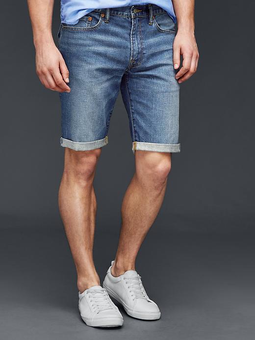 1 of 8 showing, with the color worn medium blue of product STRETCH 1969 slim fit denim shorts (10")