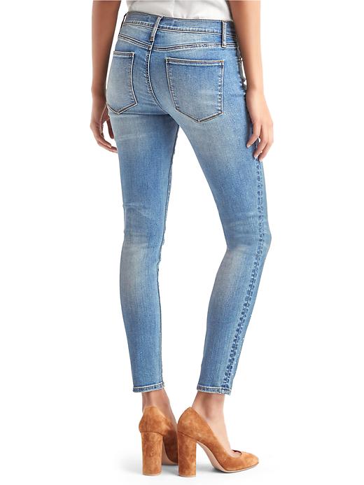 2 of 8 showing, with the color light indigo of product Mid rise gem-studded true skinny jeans