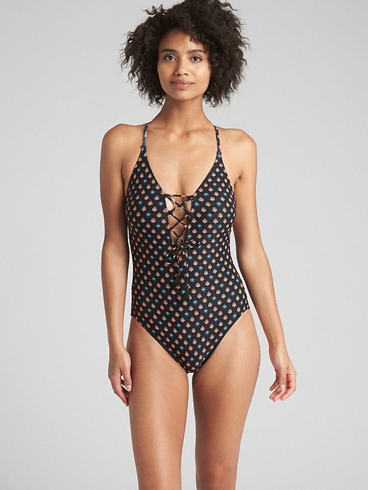 1 of 8 showing, with the color ditsy black of product Lace-Up Print Crossback One-Piece Suit