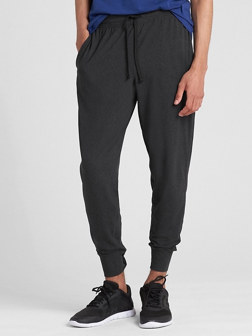 View large product image 1 of 1. GapFit Brushed Tech Jersey Joggers