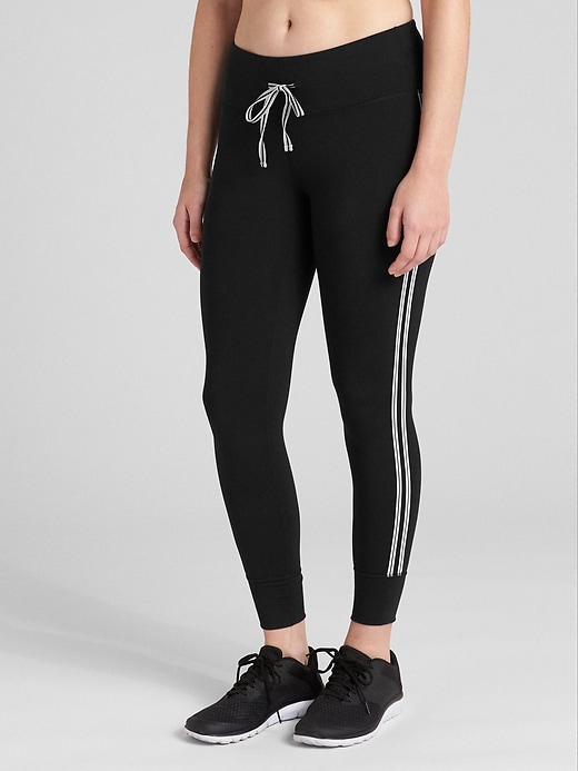 1 of 8 showing, with the color black of product GapFit Blackout Drawcord Side-Stripe 7/8 Leggings