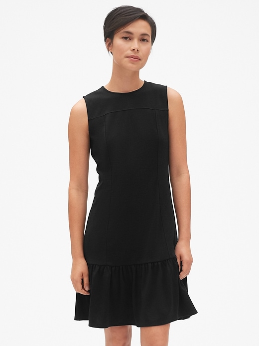 1 of 8 showing, with the color true black of product Sleeveless Flounce Dress in Ponte