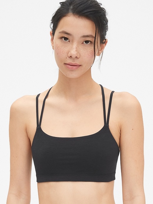 1 of 8 showing, with the color true black of product GapFit Breathe Low Support Strappy Sports Bra