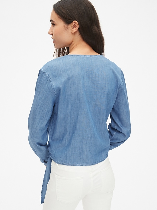 2 of 8 showing, with the color medium indigo of product Long Sleeve Wrap Top in TENCEL™