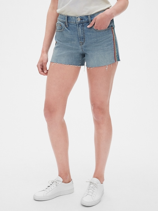 1 of 8 showing, with the color medium indigo of product Gap + Pride Mid Rise 3" Embroidered Denim Shorts