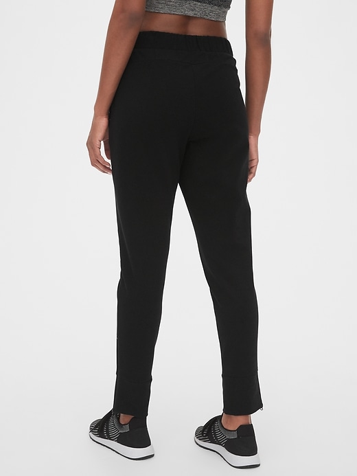 2 of 8 showing, with the color true black of product GapFit All Elements Fleece Slim Straight Joggers