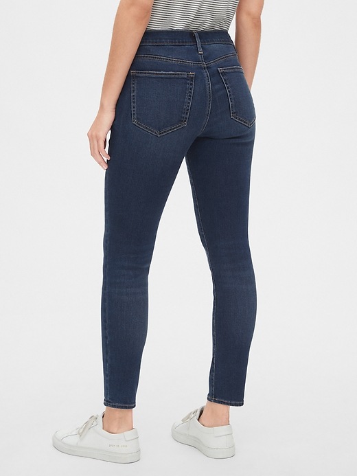 2 of 8 showing, with the color dark indigo of product Soft Wear Mid Rise True Skinny Ankle Jeans