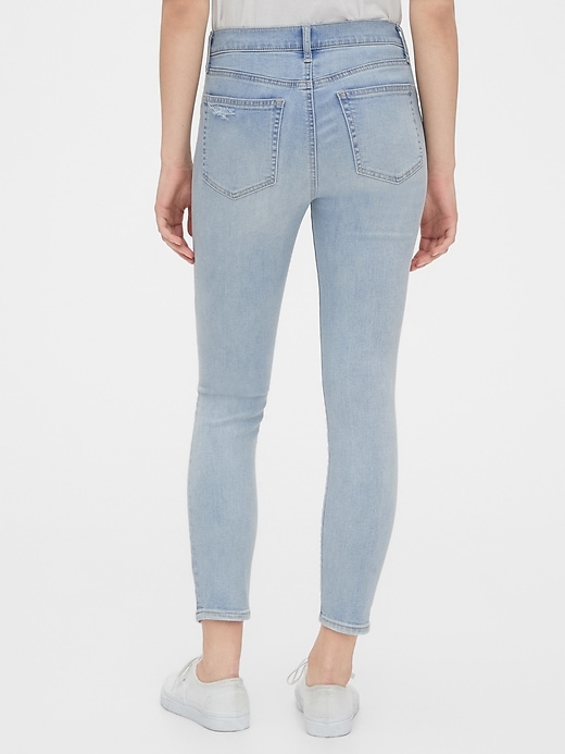 2 of 8 showing, with the color light indigo destroy of product Mid Rise Destructed True Skinny Ankle Jeans