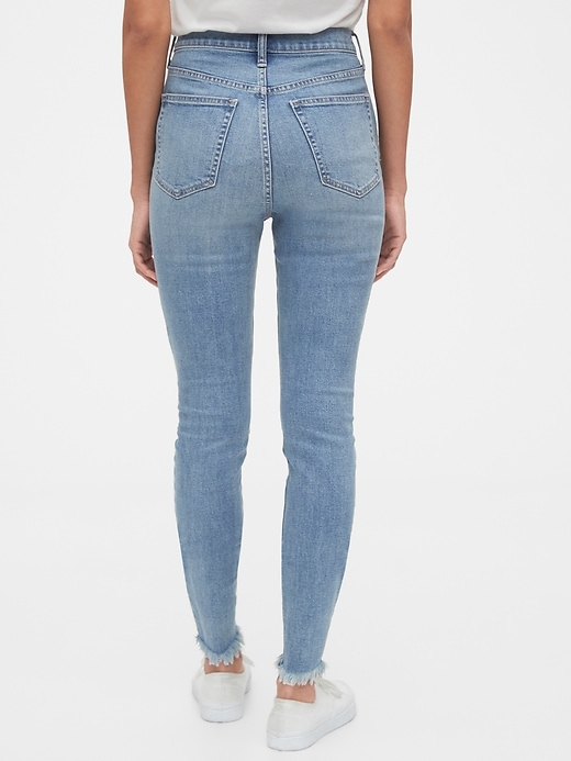 2 of 8 showing, with the color medium indigo of product Sky High Destructed True Skinny Ankle Jeans