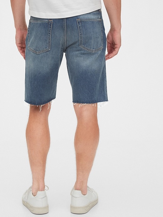 2 of 8 showing, with the color tinted repair of product 12" Destructed Denim Shorts with Raw Hem