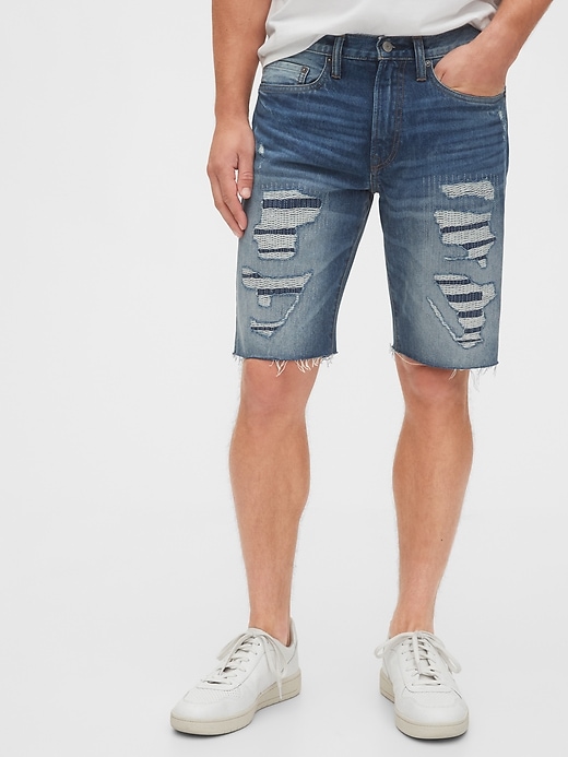 1 of 8 showing, with the color tinted repair of product 12" Destructed Denim Shorts with Raw Hem