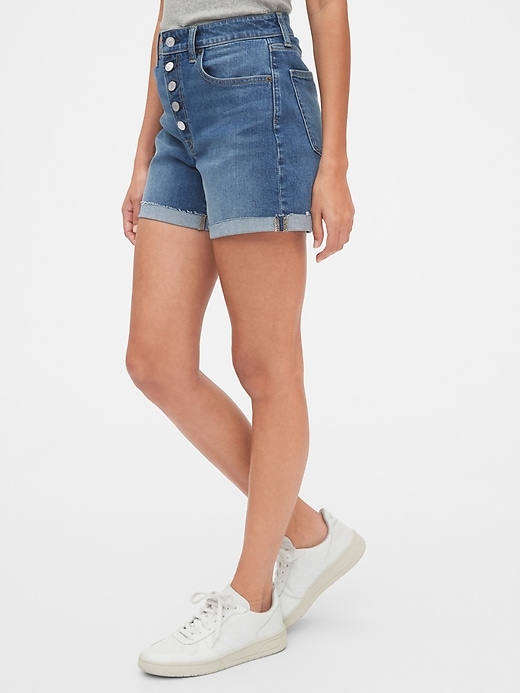 1 of 8 showing, with the color medium indigo of product 4" High Rise Curvy Denim Shorts With Raw Hem
