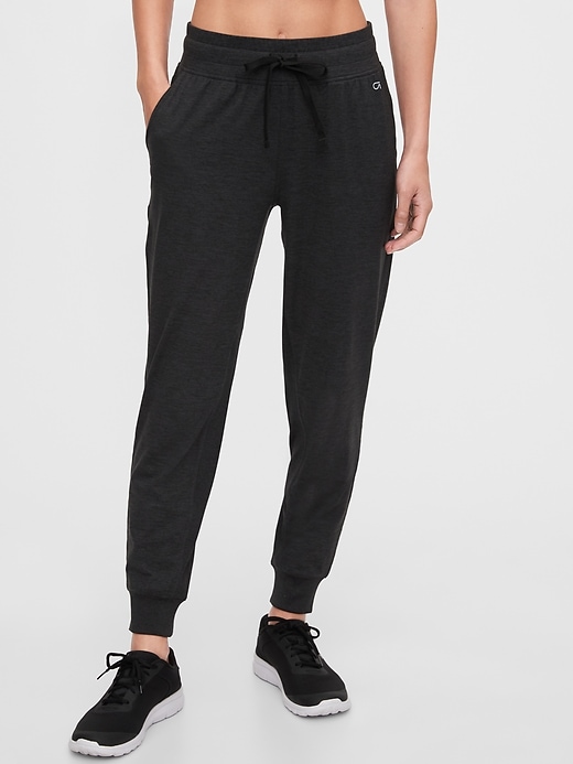 View large product image 1 of 1. GapFit Brushed Tech Jersey Joggers