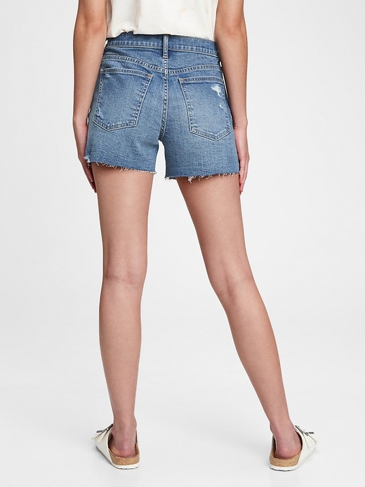 2 of 8 showing, with the color medium indigo of product 3'' Mid Rise Distressed Denim Shorts With Washwell™