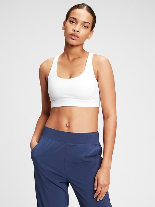 1 of 8 showing, with the color optic white of product GapFit Blackout Medium Impact Crossback Sports Bra