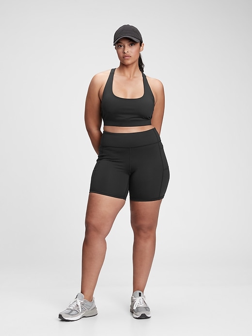 1 of 8 showing, with the color true black of product GapFit Blackout Medium Impact Crossback Sports Bra