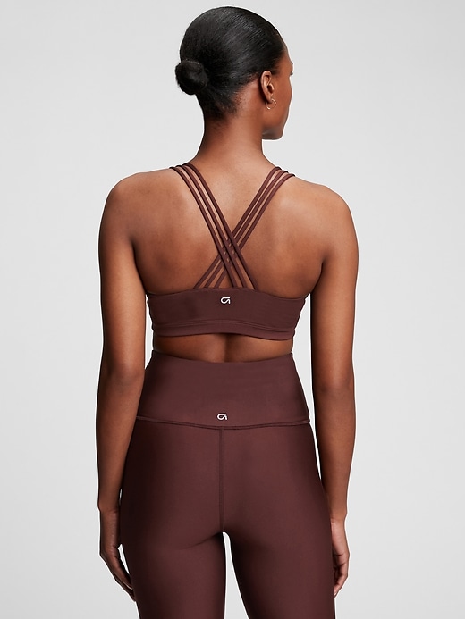 2 of 8 showing, with the color cherrywood red of product GapFit Eclipse Medium Support Strappy Sports Bra