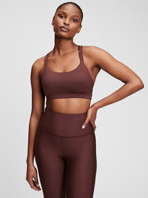 1 of 8 showing, with the color cherrywood red of product GapFit Eclipse Medium Support Strappy Sports Bra