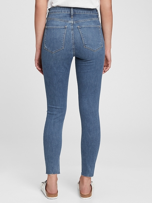 2 of 8 showing, with the color medium indigo of product High Rise Distressed Universal Jegging with Secret Smoothing Pockets