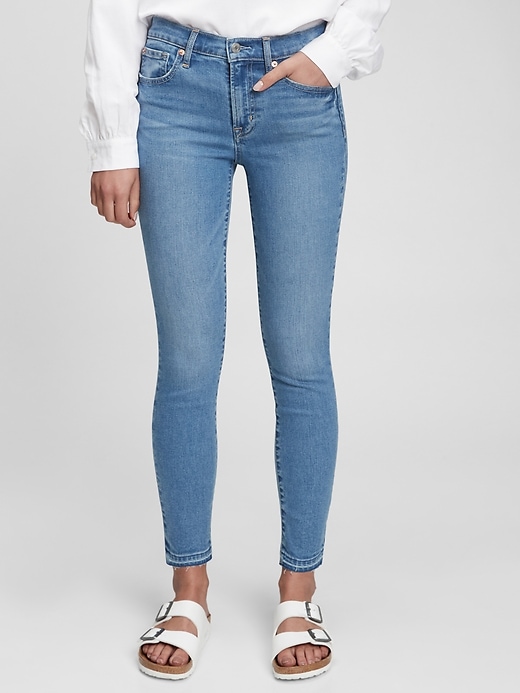 1 of 8 showing, with the color light indigo of product Mid Rise True Skinny Jeans with Washwell