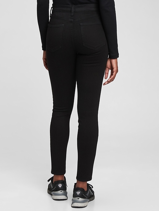 2 of 8 showing, with the color black rinse of product Mid Rise True Skinny Jeans with Washwell