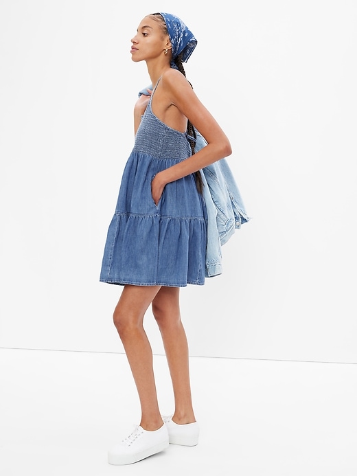 1 of 8 showing, with the color medium indigo of product Denim Smocked Mini Dress