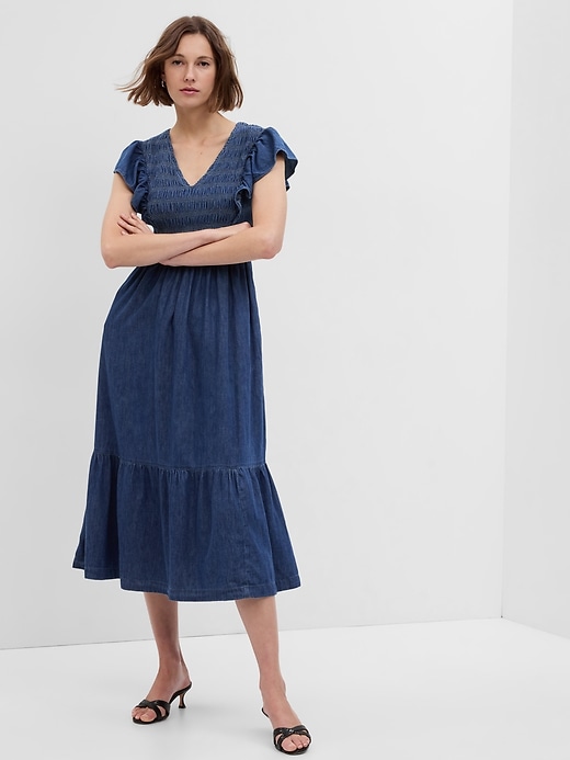 1 of 8 showing, with the color dark indigo of product Organic Cotton Denim Ruffle Sleeve Smocked Midi Dress