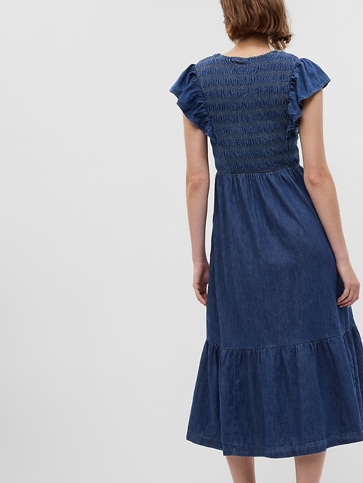 2 of 8 showing, with the color dark indigo of product Organic Cotton Denim Ruffle Sleeve Smocked Midi Dress