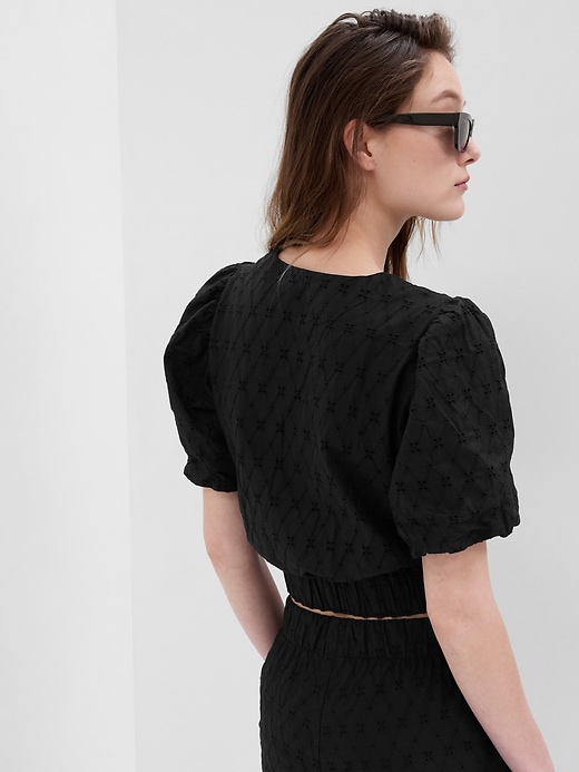 2 of 8 showing, with the color black of product Puff Sleeve Eyelet Wrap Top