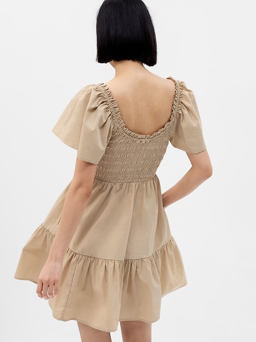 2 of 8 showing, with the color sand khaki tan of product Flutter Sleeve Smocked Mini Dress