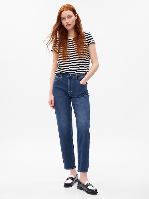 1 of 8 showing, with the color medium indigo of product High Rise Taper Jeans