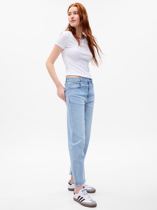 1 of 8 showing, with the color light indigo of product High Rise Taper Jeans