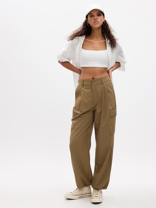 1 of 8 showing, with the color dried moss khaki tan of product GapFit High Rise Ripstop Parachute Cargo Pants
