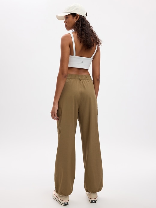 2 of 8 showing, with the color dried moss khaki tan of product GapFit High Rise Ripstop Parachute Cargo Pants