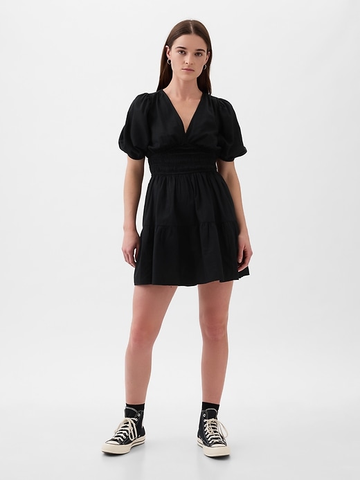 1 of 8 showing, with the color BLACK of product Puff-Sleeve Smocked Mini Dress