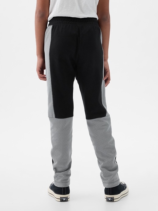 2 of 8 showing, with the color black colorblock of product GapFit Kids Fit Tech Pants