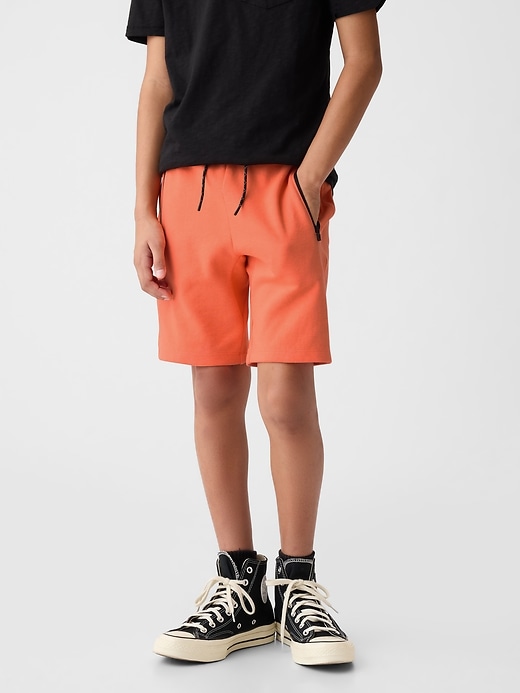 1 of 8 showing, with the color neon orange bolt of product Kids GapFit 7" Fit Tech Shorts