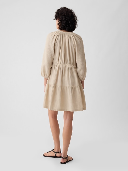 2 of 8 showing, with the color bedrock beige of product Crinkle Gauze Tiered Mini Dress