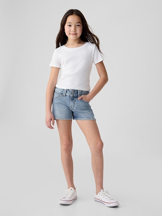 1 of 8 showing, with the color medium wash of product Kids Low Rise Y2K Denim Shortie Shorts