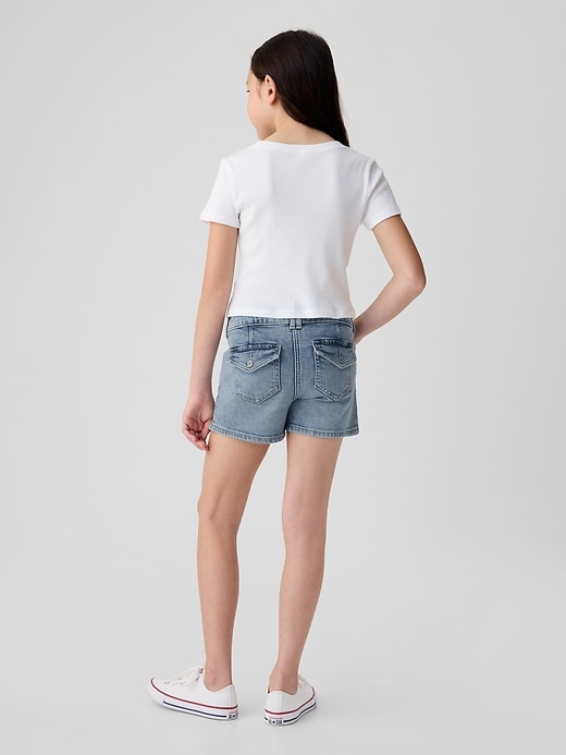 2 of 8 showing, with the color medium wash of product Kids Low Rise Y2K Denim Shortie Shorts
