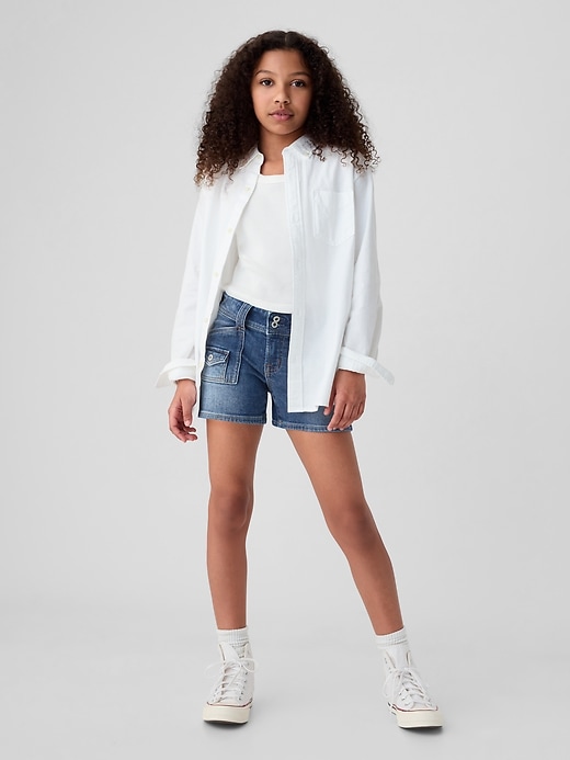 1 of 8 showing, with the color medium wash of product Kids Low Rise Y2K Denim Shortie Shorts