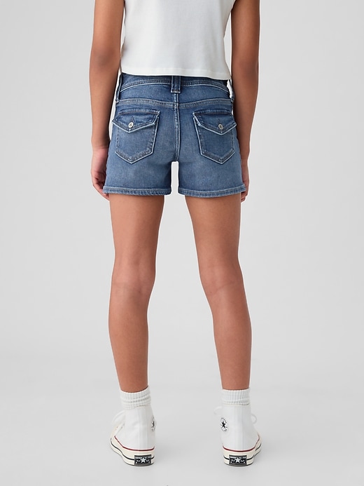 2 of 8 showing, with the color medium wash of product Kids Low Rise Y2K Denim Shortie Shorts