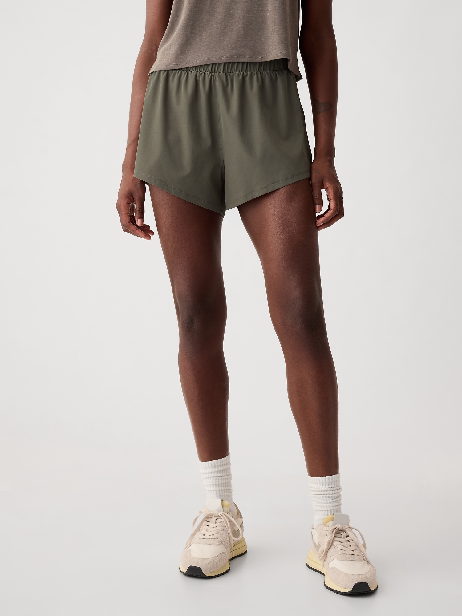 Shop Gap Fit Mid Rise Dolphin Running Shorts In Greenish Grey