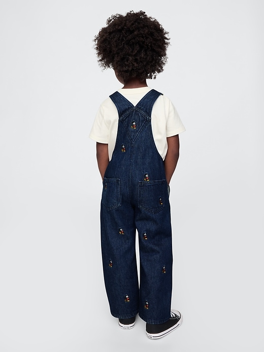 2 of 8 showing, with the color dark wash of product Gap × Disney Baby Mickey Mouse Embroidered Denim Overalls
