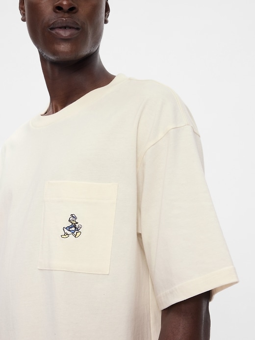 4 of 8 showing, with the color Donald Duck ivory frost of product Gap × Disney Heavyweight Pocket T-Shirt